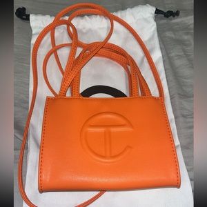 Small orange telfar bag with dust bag